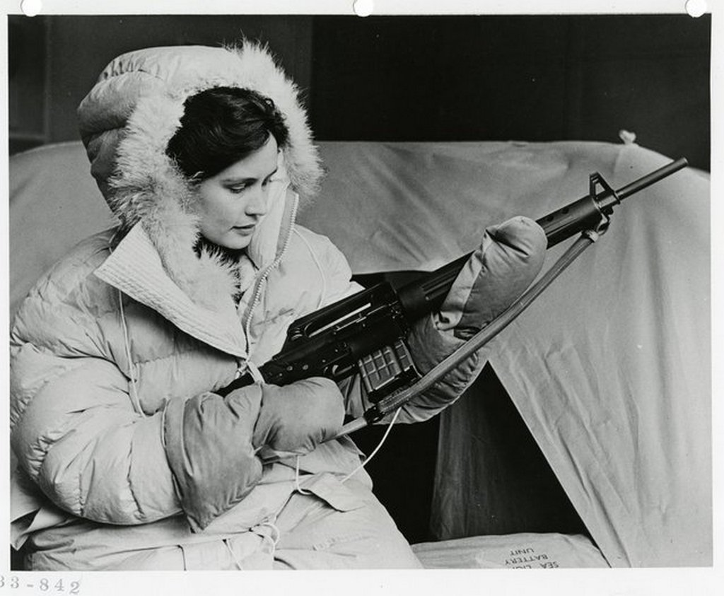 1959_klm_flight_attendant_displays_her_ar-10_rifle_and_parka_two_parts_of_polar_survival_gear_issued_to_commercial_aircrews_flew_over_the_north_pole_the_rifle_was_intended_to_defend_against_bear.jpg