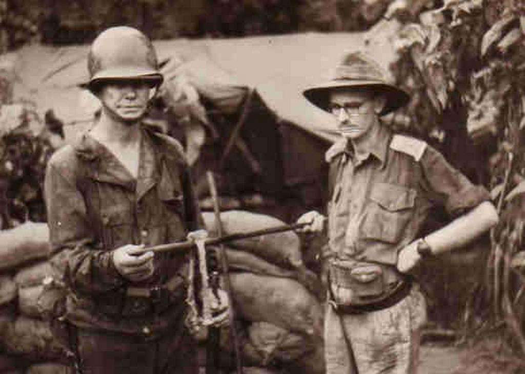 1943_papua_allied_officers_holding_the_forearm_bones_from_american_officer_who_was_mia_near_sanananda_point_and_probably_got_eaten_by_japanese_soldiers_all_of_the_flesh_had_been_stripped_from_these_bones_and_other.jpg