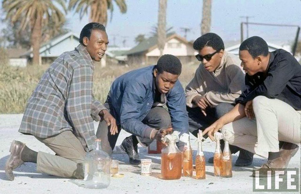 1966_gang_members_pour_motor_oil_into_glass_bottles_to_make_molotov_cocktails_in_the_watts_neighborhood_los_angeles_california.jpg