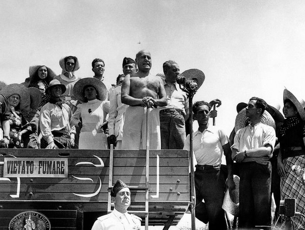 1938_benito_mussolini_stands_on_a_wheat_threshing_machine_in_aprilia_italy_to_inaugurate_the_harvest_of_1938.jpg