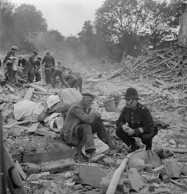 1944_a_police_officer_attempts_to_console_an_elderly_man_after_his_wife_was_killed_in_a_v1_doodlebug_flying_bomb_attack_england.jpg