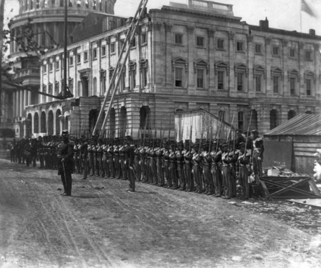 1861_may_a_few_weeks_after_the_outbreak_of_the_civil_war_united_states_union_soldiers_begin_guarding_washington_d_c_from_rebel_attacks_as_construction_of_the_capitol_building_continues_on_around_them.jpg