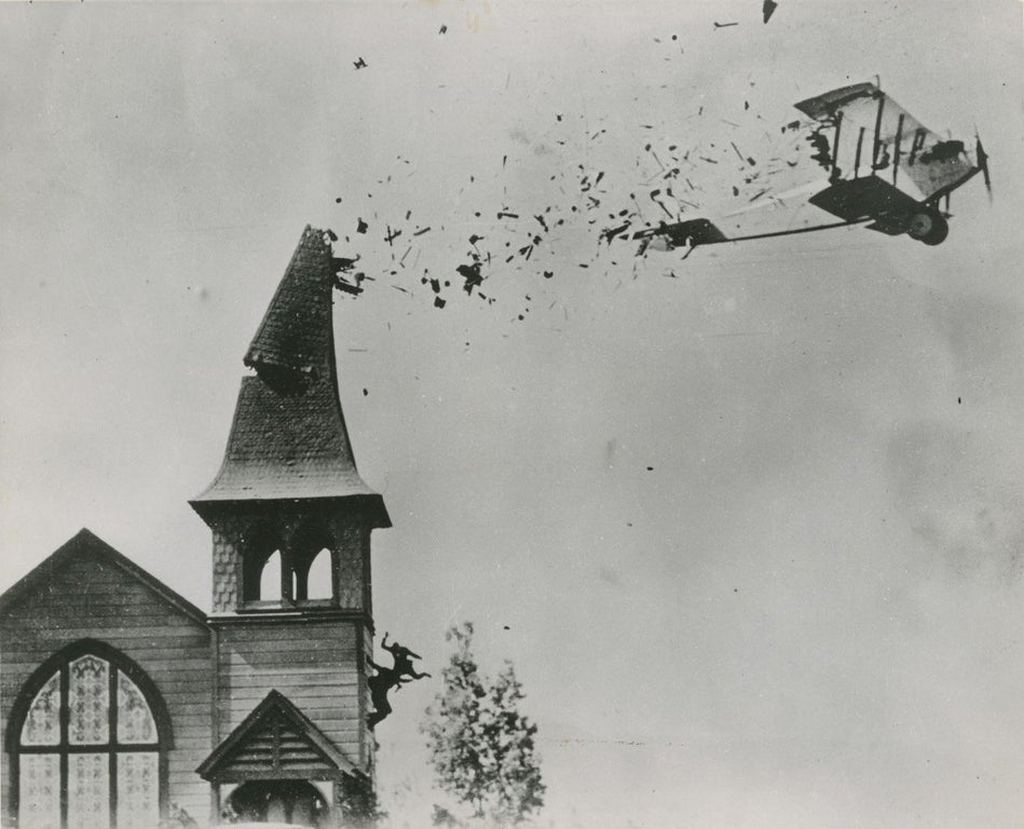 1920_pilot_omar_lockyear_flying_his_plane_through_a_breakaway_church_steeple_while_filming_the_lost_silent_movie_the_skywayman.jpg