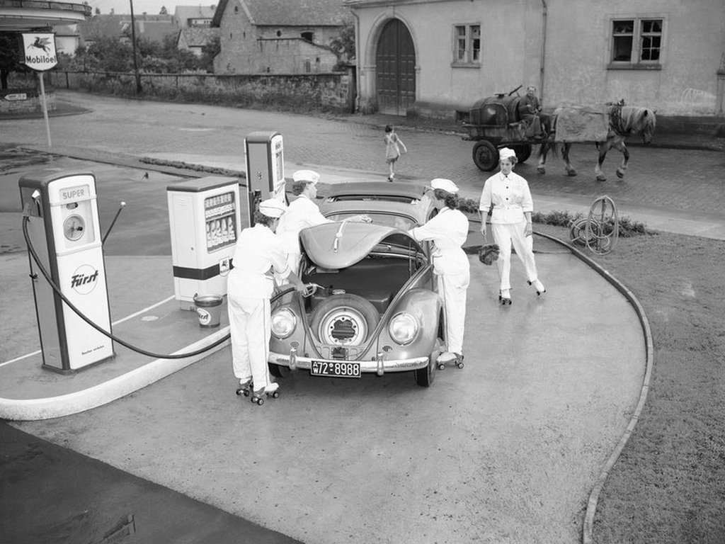 1954_employees_on_roller-skates_tend_to_a_volkswagen_at_a_gas_station_in_deidesheim_germany.jpg