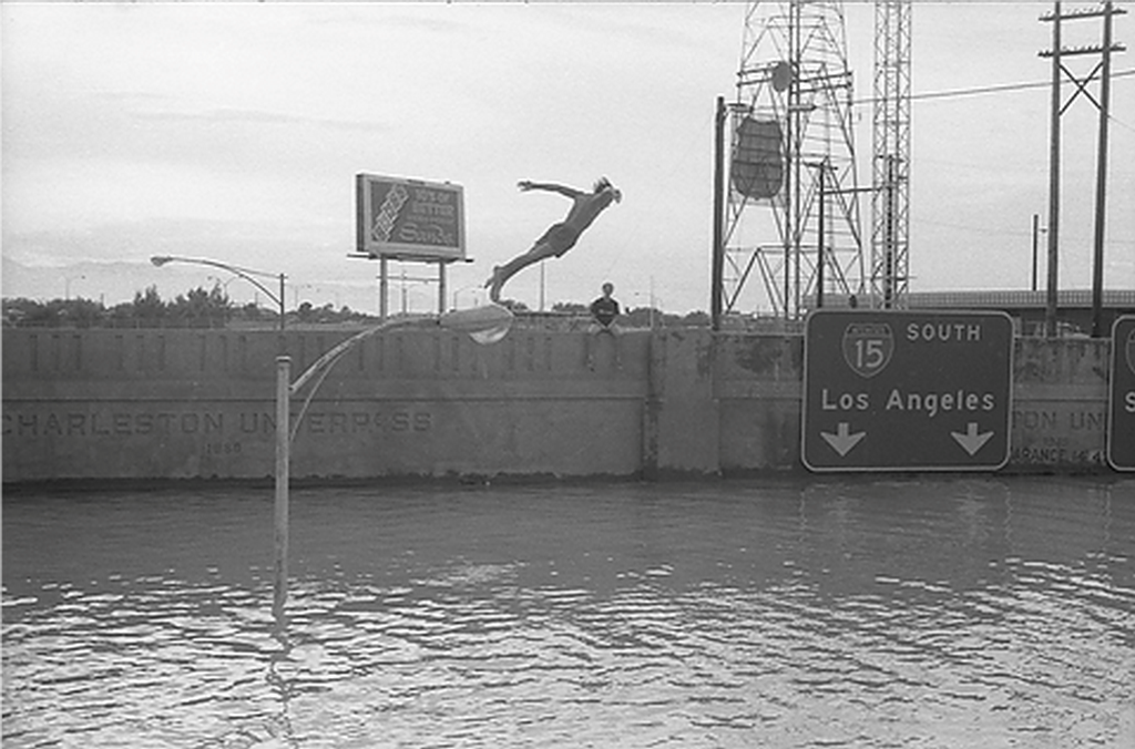 1950_teen_jumping_into_flood_waters_from_a_light_pole_in_las_vegas.png