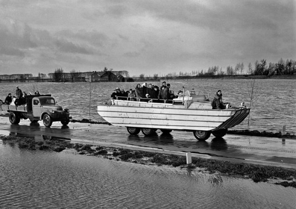 1953_a_loaded_amphibian_tows_a_broken_down_lorry_also_loaded_with_refugees_during_rescue_operations_on_the_devastated_zuid_beveland_holland_february_6.jpg