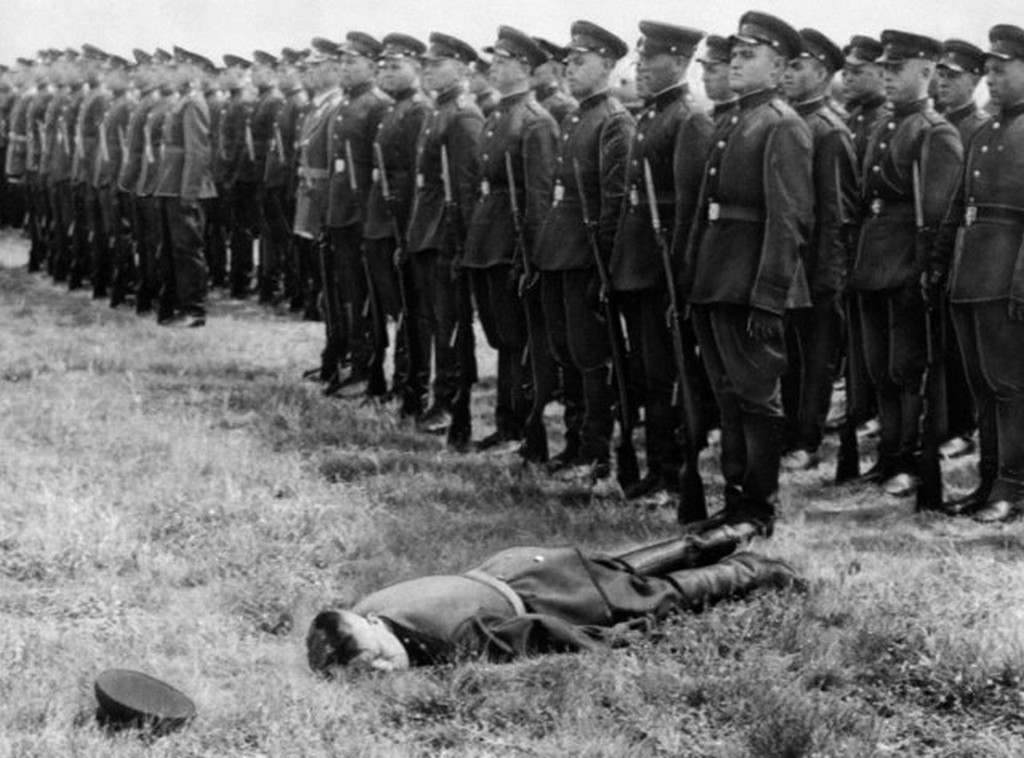 1956_a_soviet_soldier_fainted_at_a_parade_at_brandenburg_airfield_in_east_germany_jun_20_the_ceremonies_were_connected_with_the_withdrawal_of_a_promised_33_500_russian_troops_from_east_germany.jpg