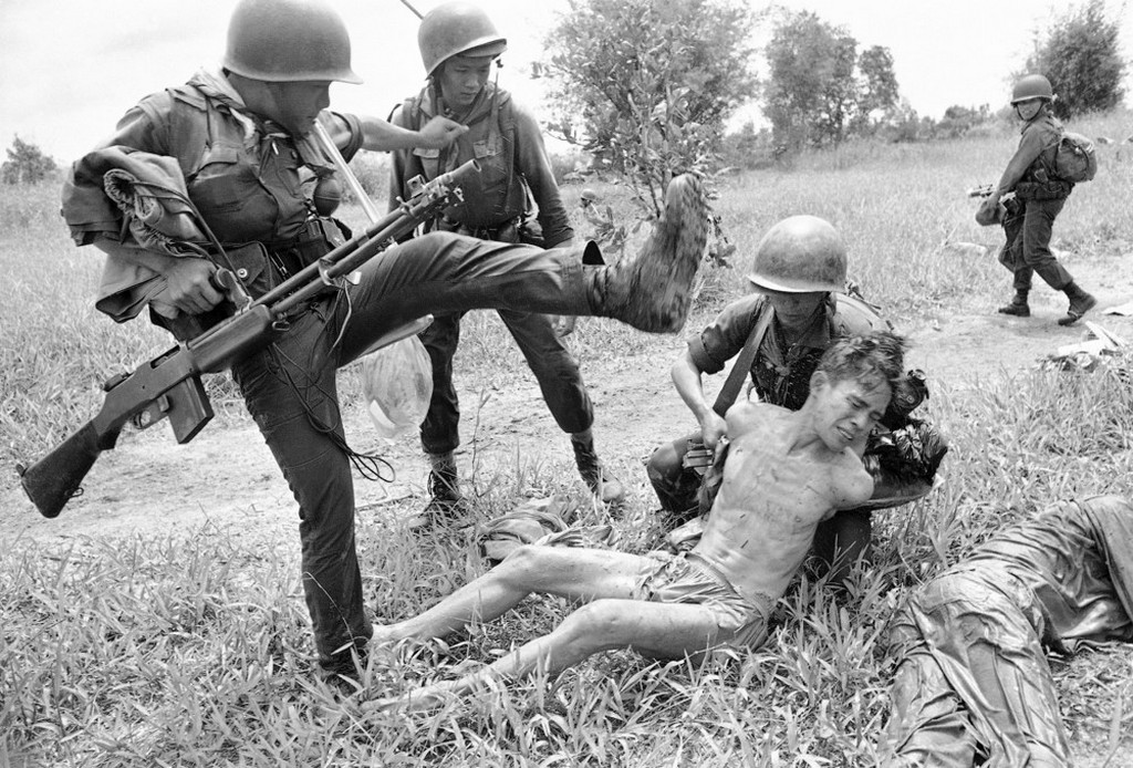 1965_a_suspected_vietcong_is_kicked_by_a_vietnamese_soldier.jpeg