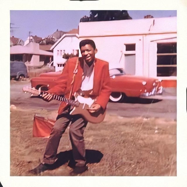 1957_a_young_15_year_old_jimi_hendrix_with_his_first_guitar.jpg