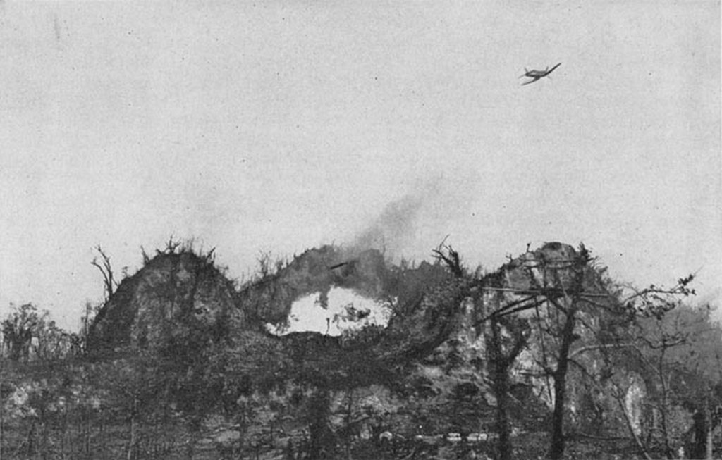 1944_oktobere_u_s_marine_corsair_fighter_drops_napalm_on_japanese_positions_atop_umurbrogol_mountain_peleliu.jpg