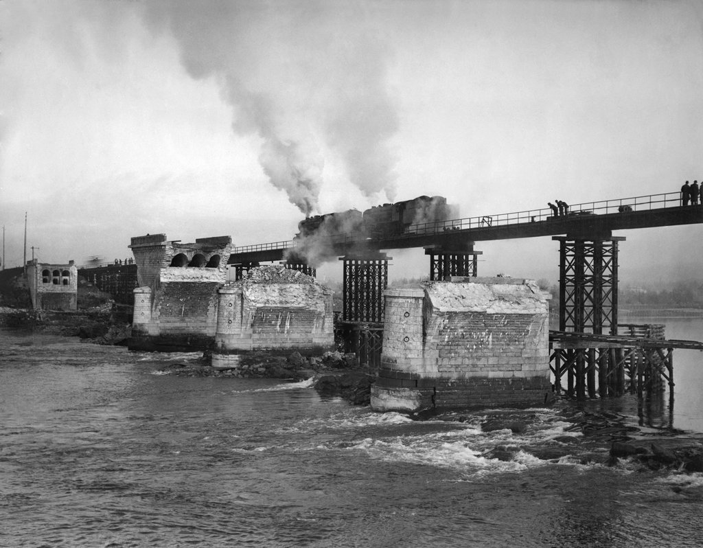 1945_a_train_tests_a_new_temporary_bridge_over_the_loire_in_nantes_france_after_the_previous_bridge_was_destroyed_by_aerial_bombardment.jpg