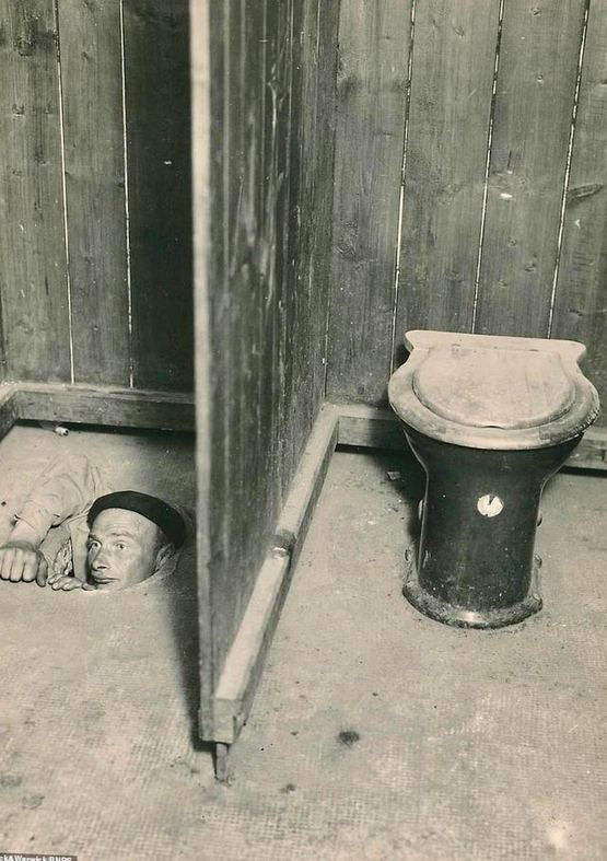 1943_an_allied_prisoner_of_war_climbing_out_of_a_sewer_after_guards_caught_him_trying_to_escape_from_colditz_prison_camp_in_leipzig_germany.jpg
