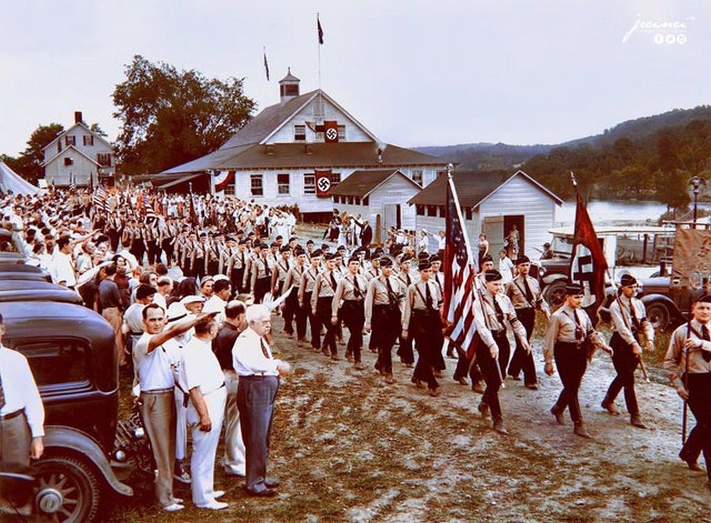 1937_nearly_1_000_uniformed_men_wearing_swastika_arm_bands_and_carrying_nazi_banners_parade_past_a_reviewing_stand_in_new_jersey_on_july_18_1937.jpg