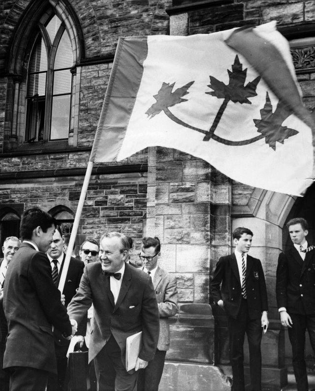 1964_prime_minister_lester_b_pearson_shaking_hands_with_university_student_who_presented_his_proposal_for_the_great_flag_debate_ottawa.jpg