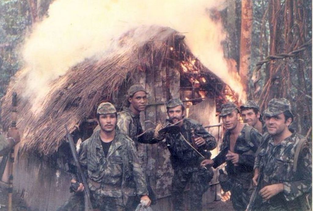 1973_portuguese_soldiers_pose_in_front_of_a_torched_hut_belonging_to_suspected_guerilla_fighters_angolan_war.jpg