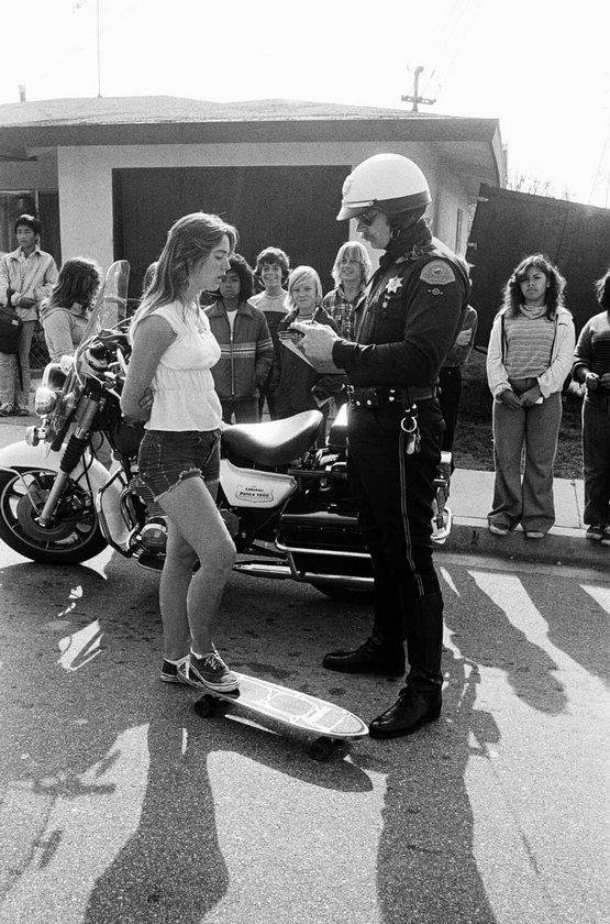 1970s_laurie_piper_getting_ticket_for_skateboarding_in_hermosa_beach_ca.jpeg