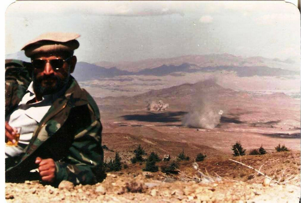 1985_korul_brigader_yasub_dogar_of_the_pakistani_isi_enjoying_a_drink_while_soviet_supply_depots_are_destroyed_in_the_background_soviet-afghan_war_gardez.png