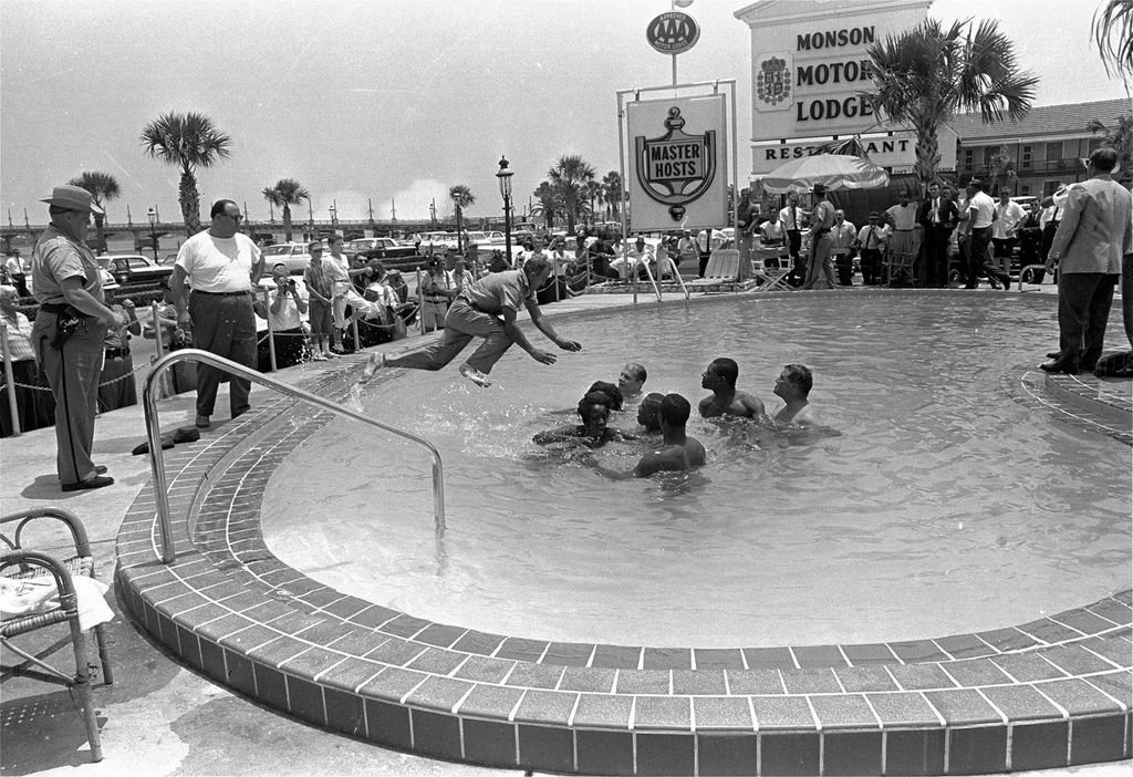 1964_police_officer_dives_into_the_pool_of_the_monson_motor_lodge_in_st_augustine_fl_to_break_up_integrationist_swim_in.jpg