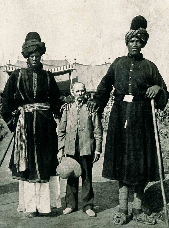 1903_two_kashmir_giants_posing_with_the_american_photographer_james_ricalton.png