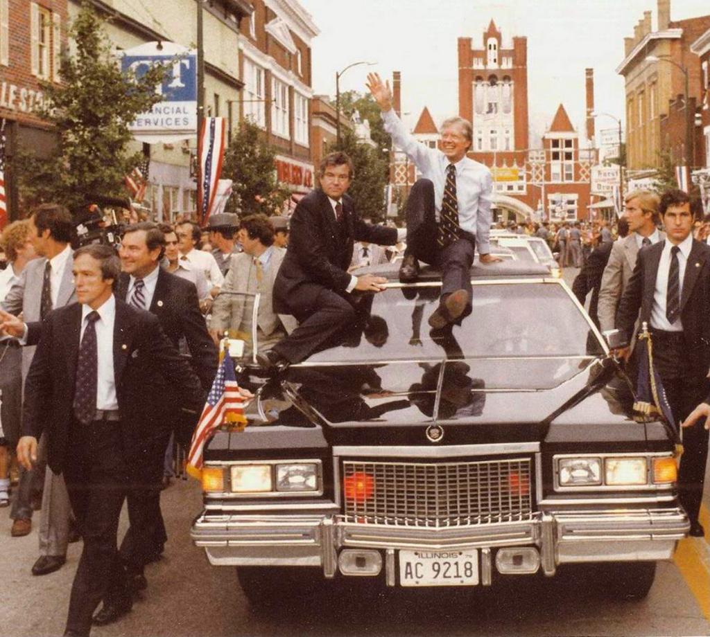 1979_president_jimmy_carter_flanked_by_nervous_secret_service_agents_climbed_onto_the_roof_of_the_presidential_limousine_during_visit_to_bardstown_kentucky.jpg