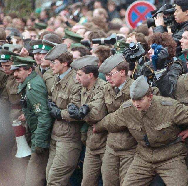 1989_west_german_police_east_german_troops_hold_back_crowds_during_the_fall_of_the_berlin_wall.jpg