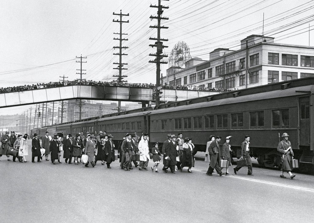 1942_citizens_of_seattle_watch_from_a_bridge_as_japanese_americans_are_evacuated_to_internment_camps.jpg