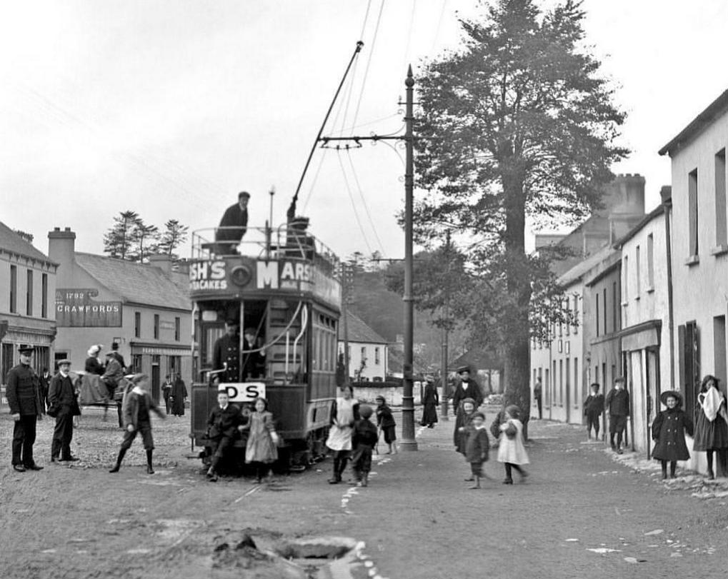 1910_street_scene_in_douglas_east_cork_ireland_with_tram_and_passengers_ireland_cr.jpg