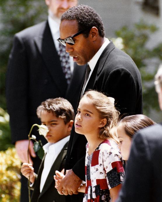 1994_o_j_simpson_holding_hands_with_his_children_justin_and_sydney_at_the_funeral_of_their_mother_and_his_ex-wife_nicole_simpson_brown_following_her_murder_los_angeles.jpg
