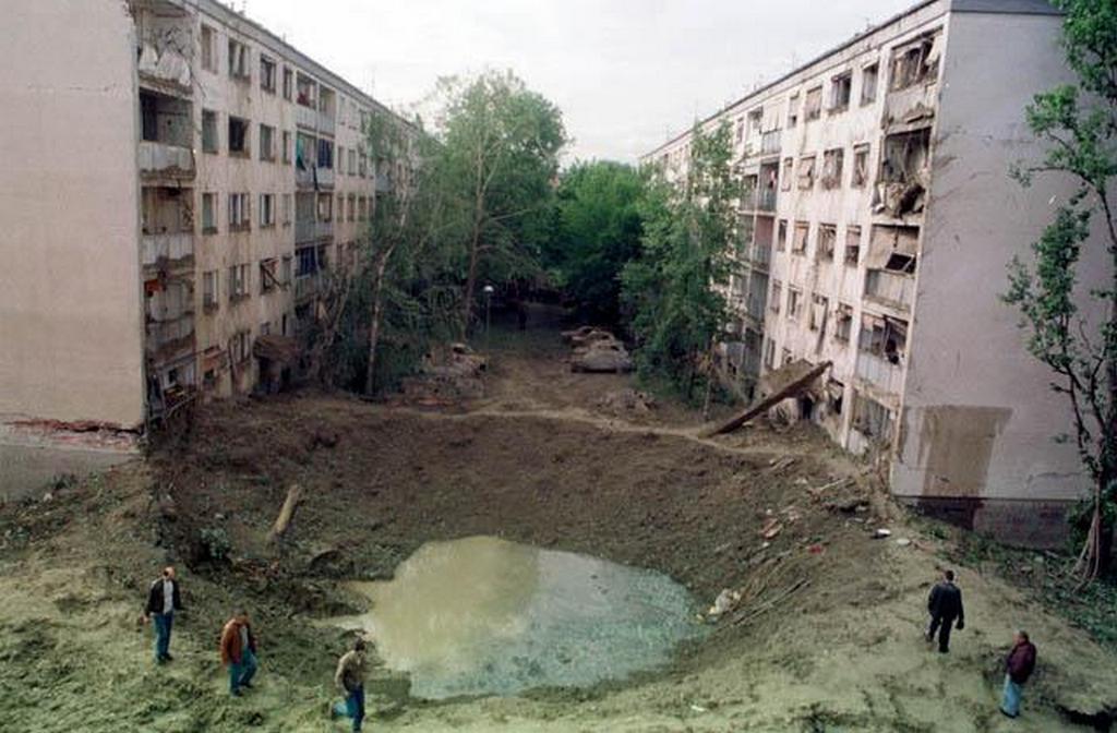 1999_crater_made_by_nato_missile_that_struck_area_between_two_apartment_buildings_and_elementary_school_during_bombing_of_yugoslavia.jpg