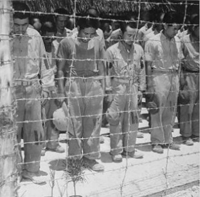 1945_aug_japanese_prisoners_of_war_at_guam_with_bowed_heads_after_hearing_emperor_hirohito_announce_japan_s_unconditional_surrender.jpg