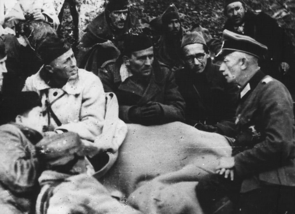 1943_yugoslav_partisans_attentively_listen_to_captured_german_major_arthur_strecker_taken_prisoner.jpg