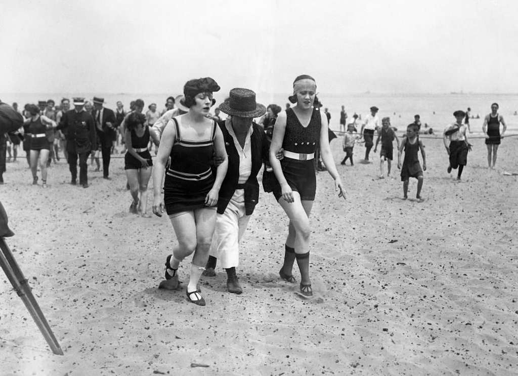1922_numerous_women_being_removed_from_the_beach_in_chicago_illinois_usa_for_wearing_bathing_suits_that_were_too_short.jpeg