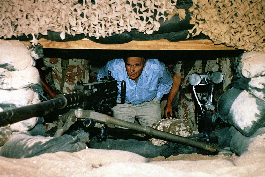 1990_president_george_h_w_bush_peers_out_from_a_bunker_at_an_m2_50-caliber_machine_gun_in_saudi_arabia.jpg