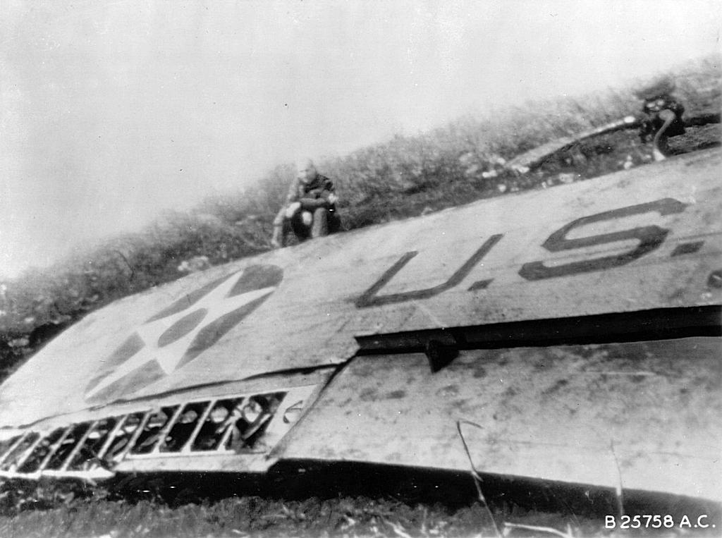 1942_gen_james_doolittle_sitting_on_the_wing_of_his_wrecked_b25_bomber_in_china_after_his_daring_raid_during_ww2.jpg