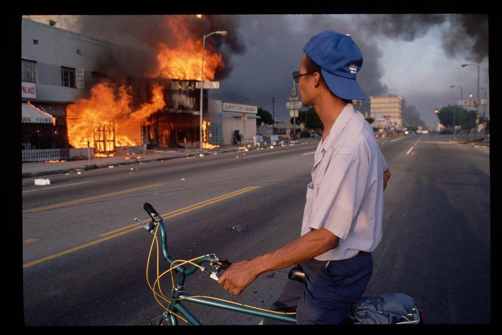 1992_a_man_watches_as_a_building_burns_during_the_1992_la_riots_a_total_of_63_people_died_during_the_riots.jpg