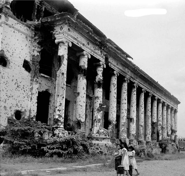1948_filipino_students_walk_past_on_one_the_war_damaged_buildings_on_the_campus_of_the_university_of_the_philippines_manila.jpg