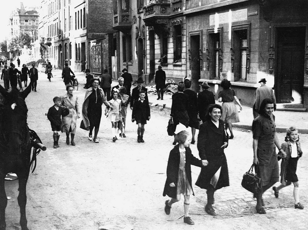 1945_06_06_german_mothers_walk_their_children_to_school_in_aachen_germany_for_registration_at_the_first_public_school_to_be_opened_by_the_u_s_military_government_after_the_war.jpg