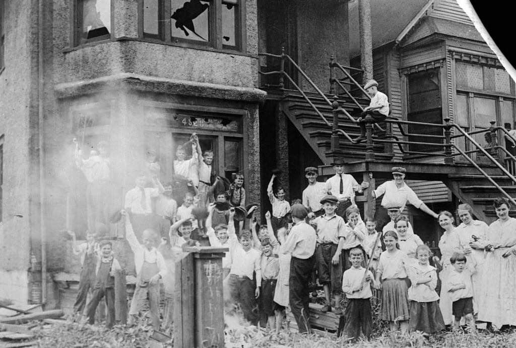 1919_jubilant_school_children_pose_for_photograph_in_front_of_a_home_of_an_african_american_family_that_they_ransacked_and_sit_alight_during_red_summer.jpg