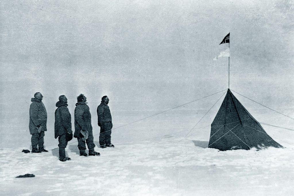 1911_december_14_roald_amundsen_and_his_crew_become_the_first_people_to_reach_the_south_pole_planting_the_norwegian_flag_and_tacking_this_photo_as_proof.jpg