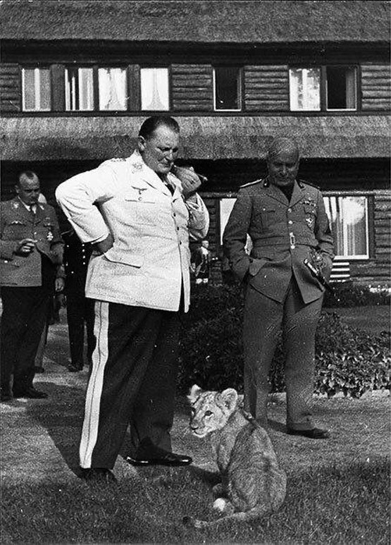 1937_hermann_goring_and_benito_mussolini_at_carinhall_with_one_of_goring_s_pet_lions_c_sar.jpg