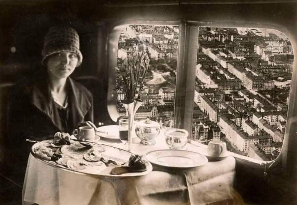 1928_lady_enjoys_meal_on_paris_to_berlin_zeppelin.jpg