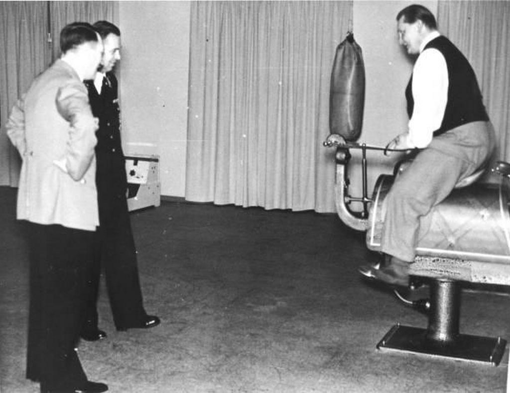 1937_reichsmarschall_hermann_goering_demonstrates_an_exercise_horse_in_the_home_gymnasium_of_his_villa_carinhall_to_adolf_hitler.jpg