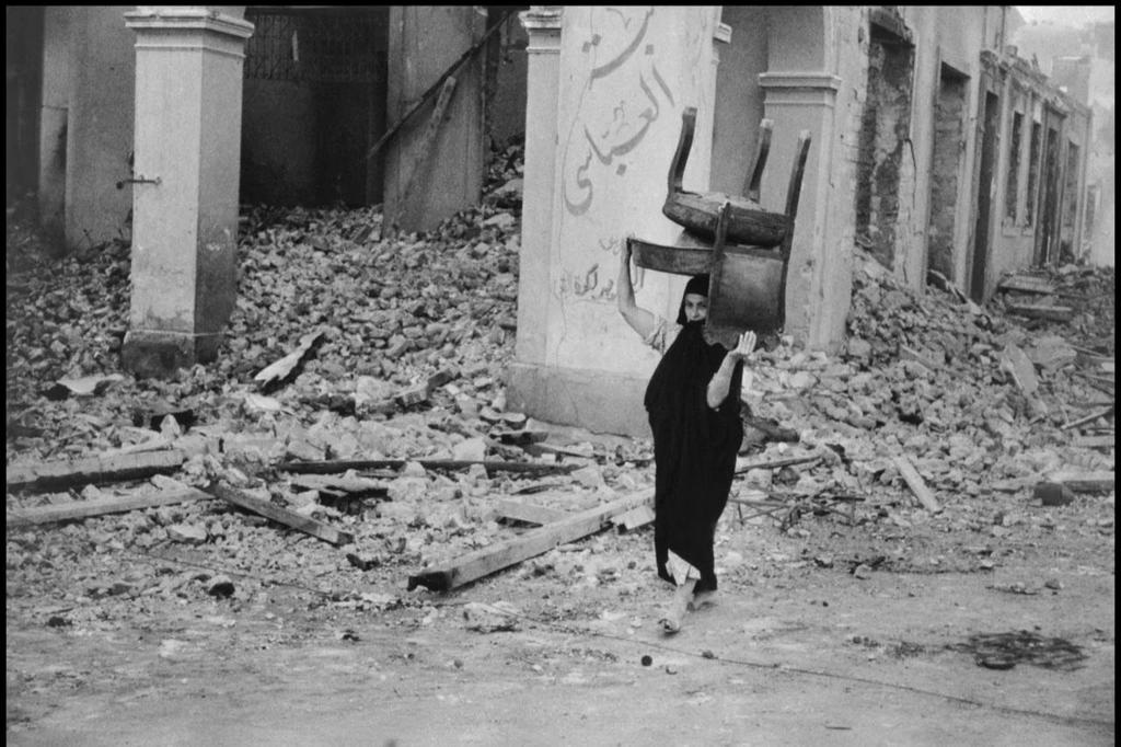 1956_a_woman_in_the_ruins_of_port_said_egypt_after_its_destruction_by_israeli_bombing_during_the_suez_crisis.jpg