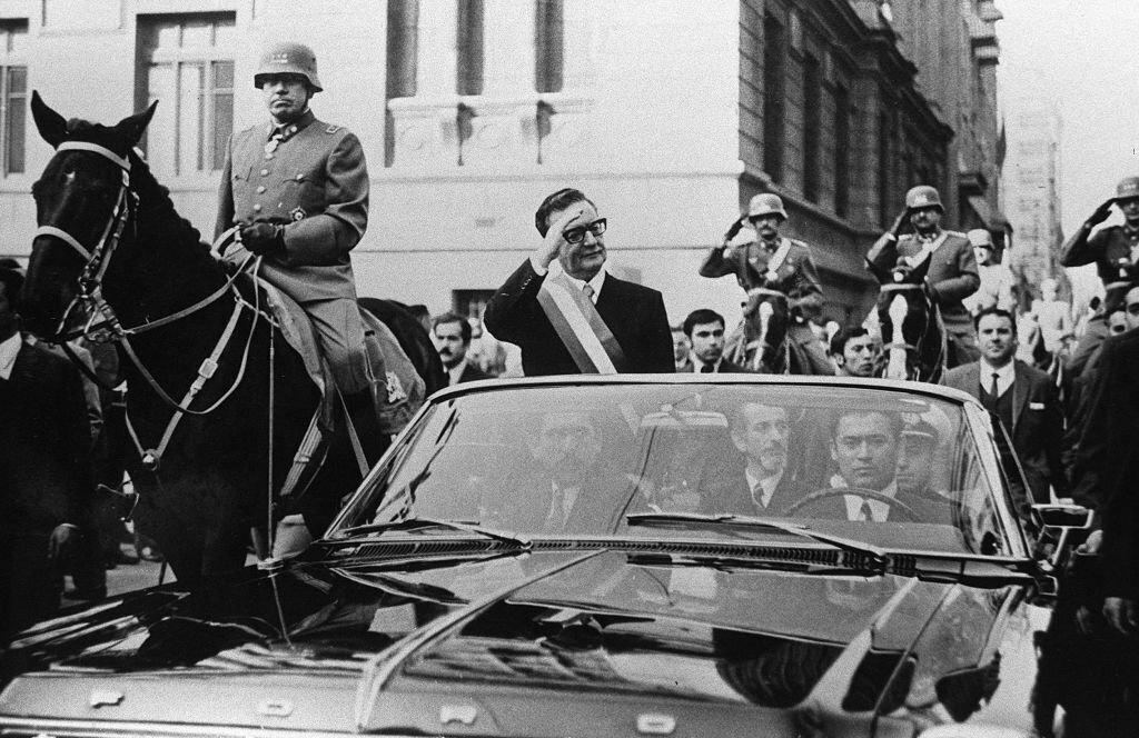 1960_chilean_president_salvador_allende_wawes_to_their_supporters_in_santiago_on_his_way_to_congress_to_deliver_his_first_message_to_the_nation_general_pinochet_riding_alongside_him.jpg