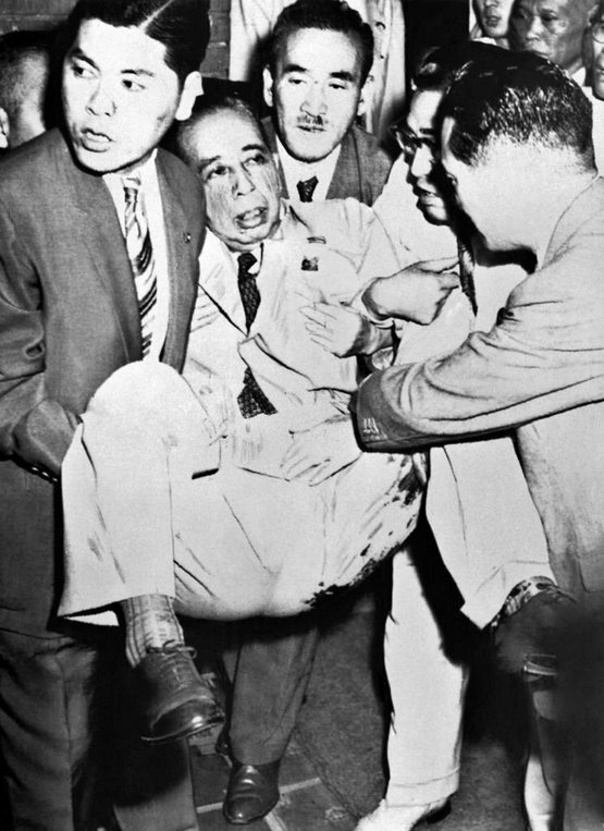 1960_japanese_prime_minister_nobusuke_kishi_is_evacuated_after_being_stabbed_six_times_in_his_left_leg_at_his_home_by_a_rightist_fanatic.jpg