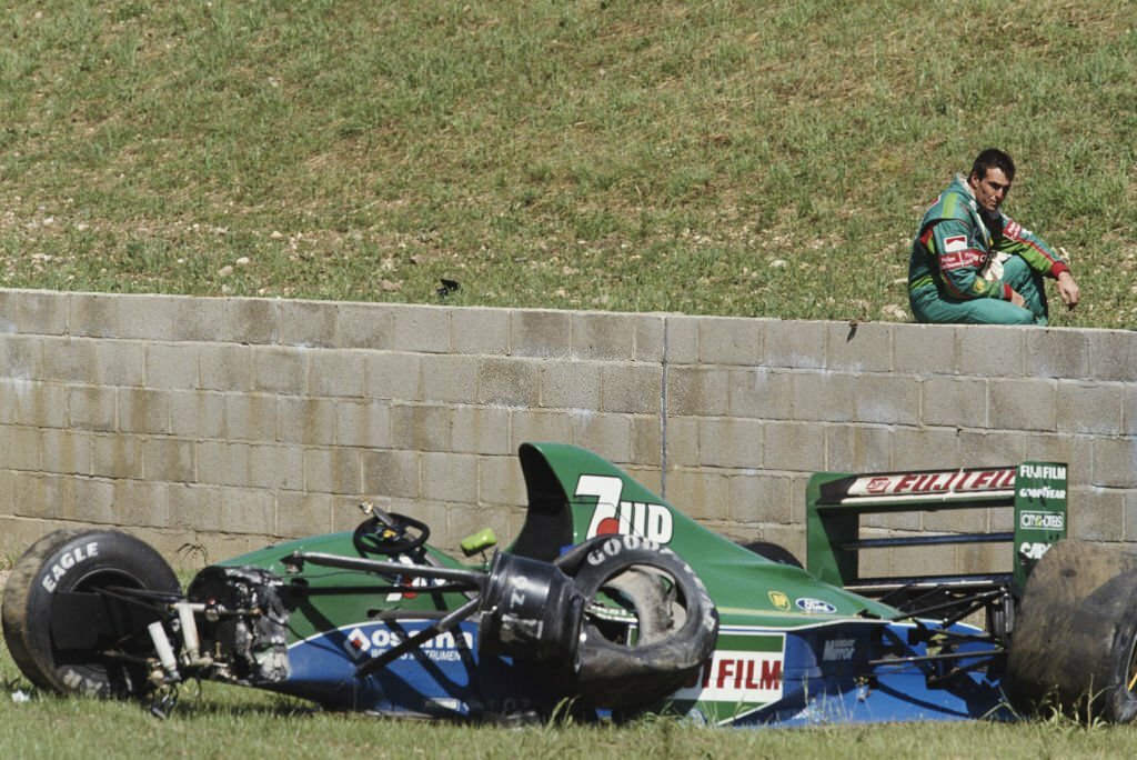 1991_andrea_de_cesaris_of_italy_sits_on_the_wall_and_surveys_the_damage_to_the_team_7up_jordan_after_crashing_out_of_the_british_grand_prix_in_silverstone.jpg