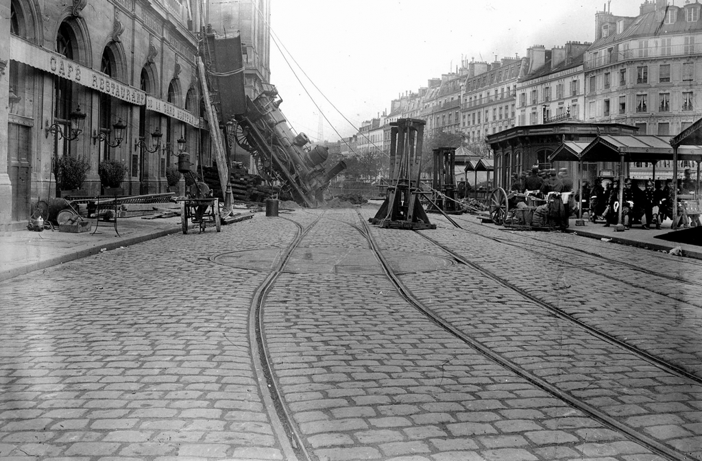 1895_accident_at_the_station_montparnasse_an_express_train_derails_after_overrunning_the_buffer_stop_crossing_30_m_of_concourse_before_crashing_through_a_wall_and_falling_to_the_road_paris.jpg