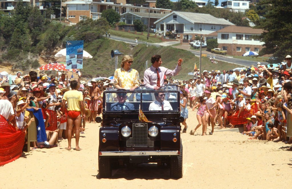 1988_prince_charles_and_diana_wave_to_the_crowds_as_they_arrive_in_an_open_top_land_rover_to_the_central_coast_surf_carnival_at_terrigal_beach_aus.jpg