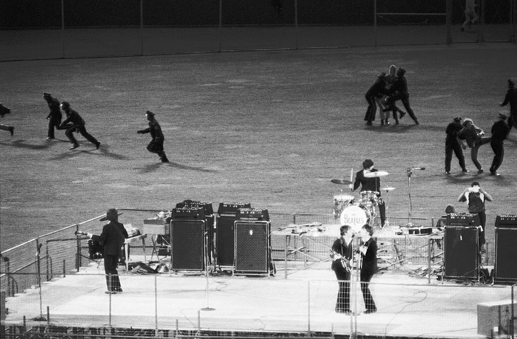 1966_policemen_clear_the_field_of_enthusiastic_fans_as_the_beatles_perform_on_a_bandstand_in_candlestick_park_san_francisco.jpg