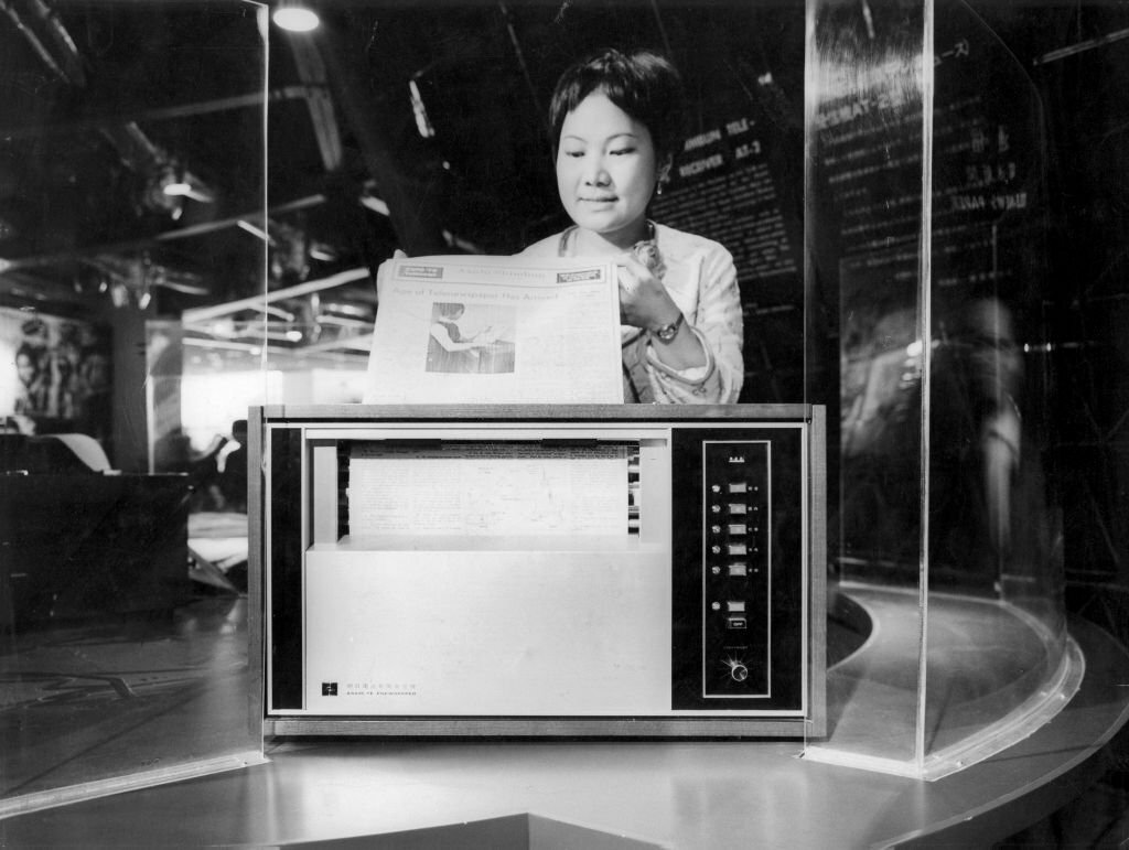 1970_the_at2_device_that_will_allow_to_receive_at_home_the_japanese_national_newspaper_asahi_shimbun_at_the_expo_the_pages_of_the_newspaper_exit_the_machine_at_the_rate_of_one_every_5_minutes.jpg